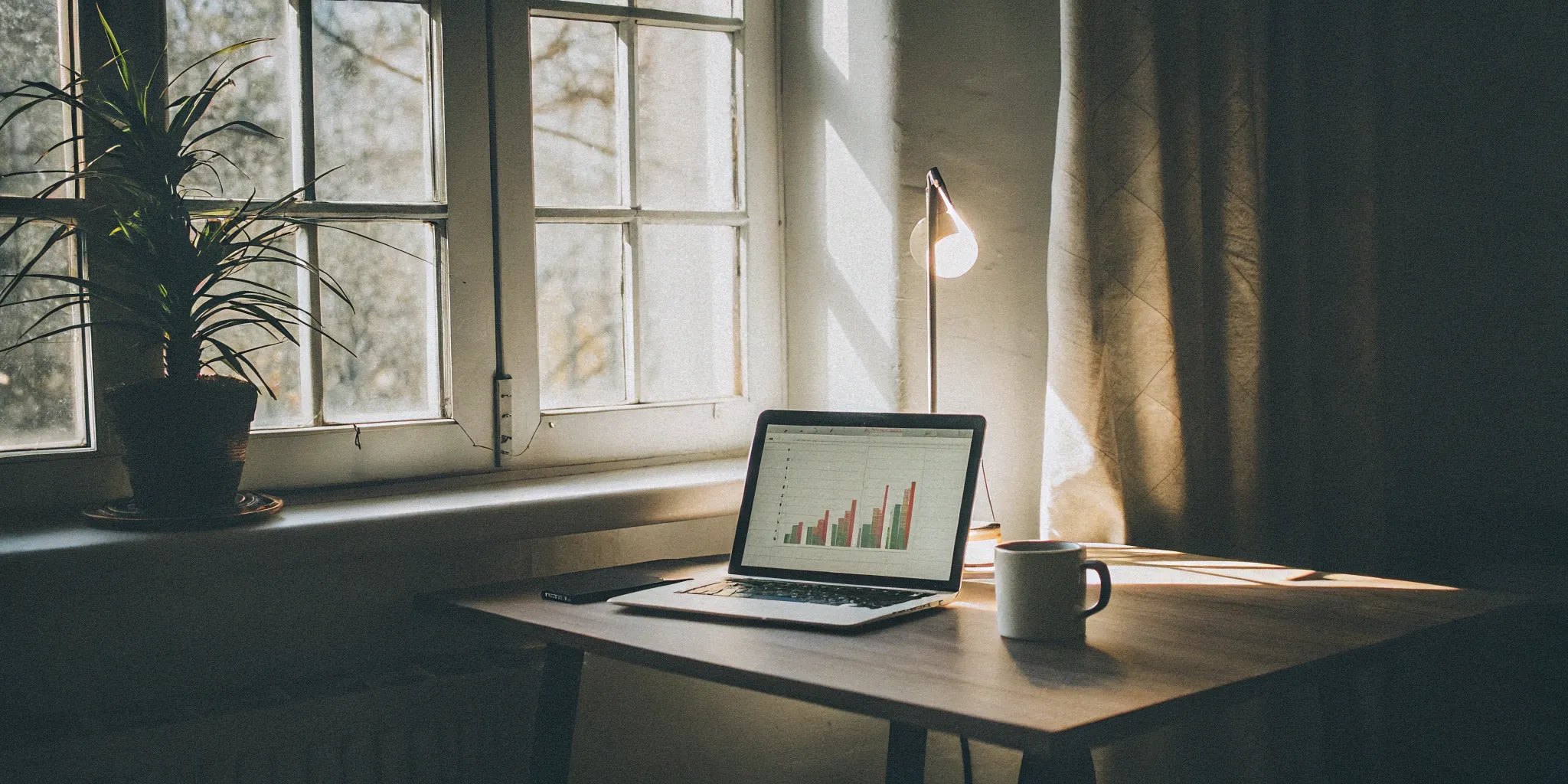 Managing home care cash flow with invoice factoring charts on a laptop.