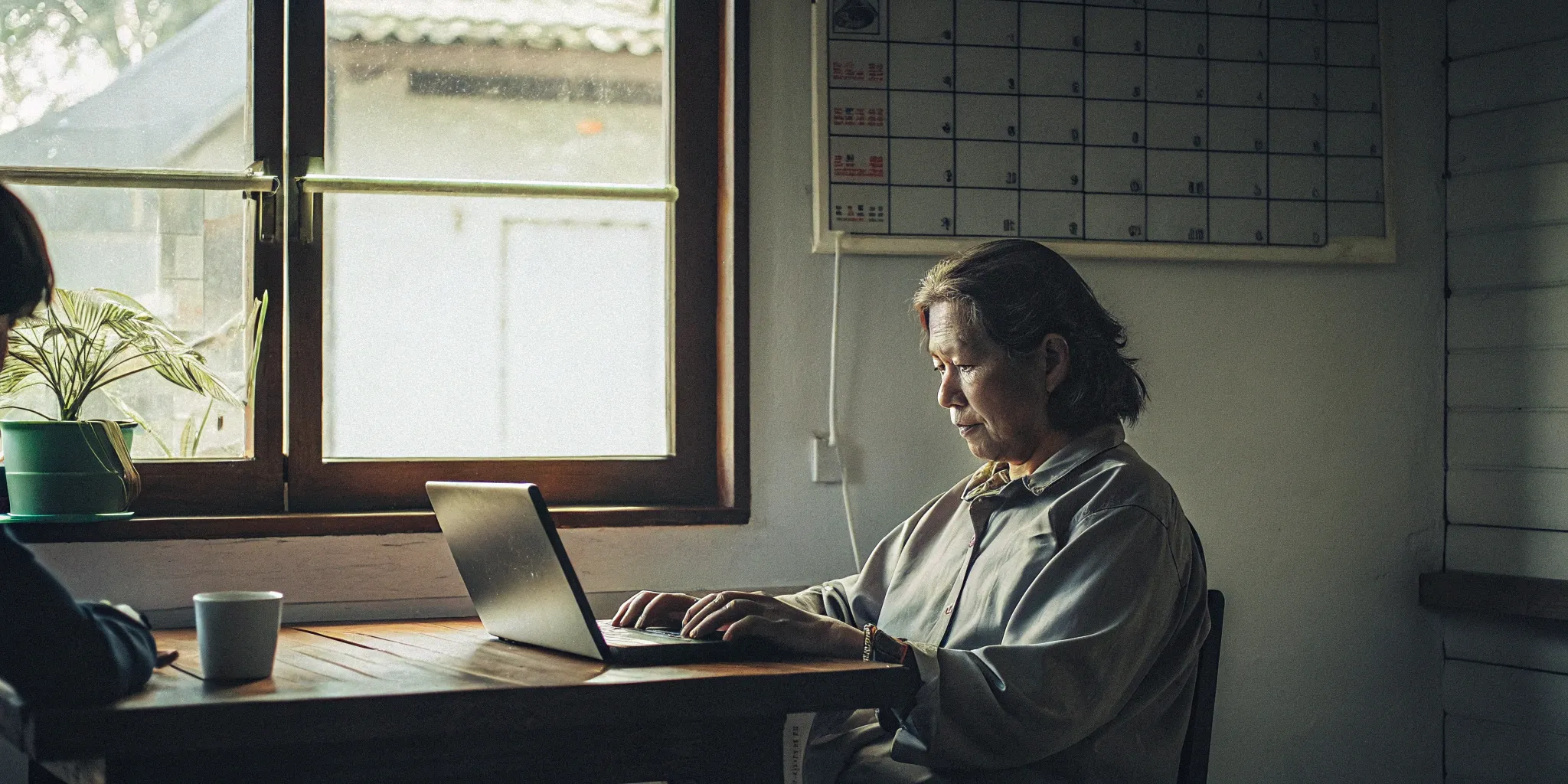 Older adult on a laptop, managing quick cash for home care payroll.